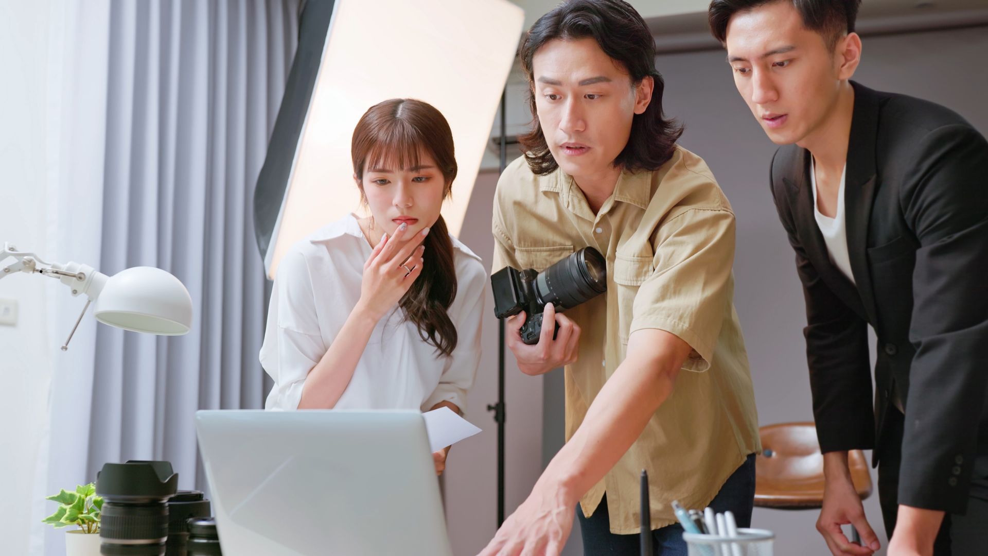 A photographer reviewing a laptop while editing